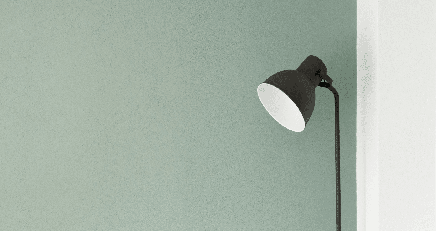 lamp in front of green wall