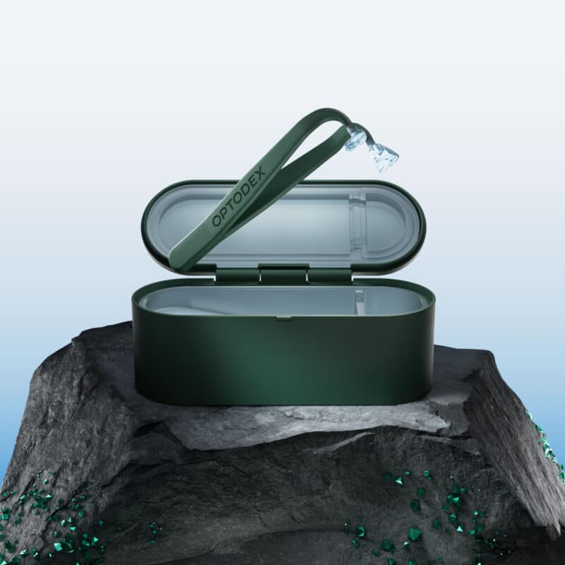 The Optodex Y-Tip contact lens applicator resting next to its disinfecting travel case.